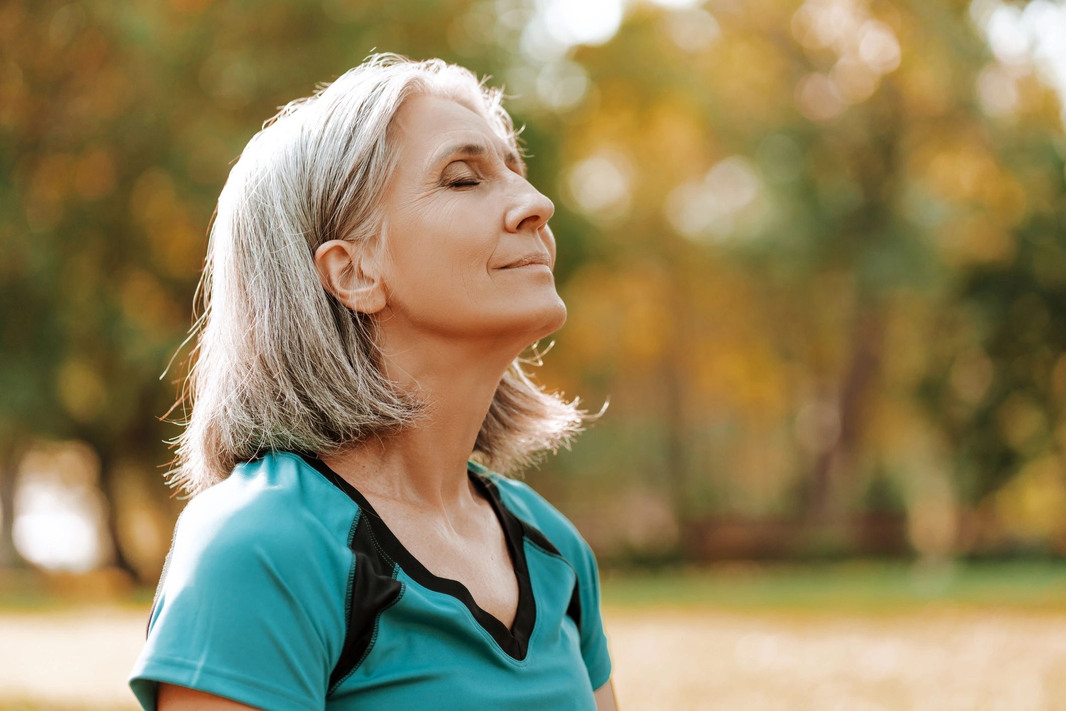 Woman taking a calming breath outdoors