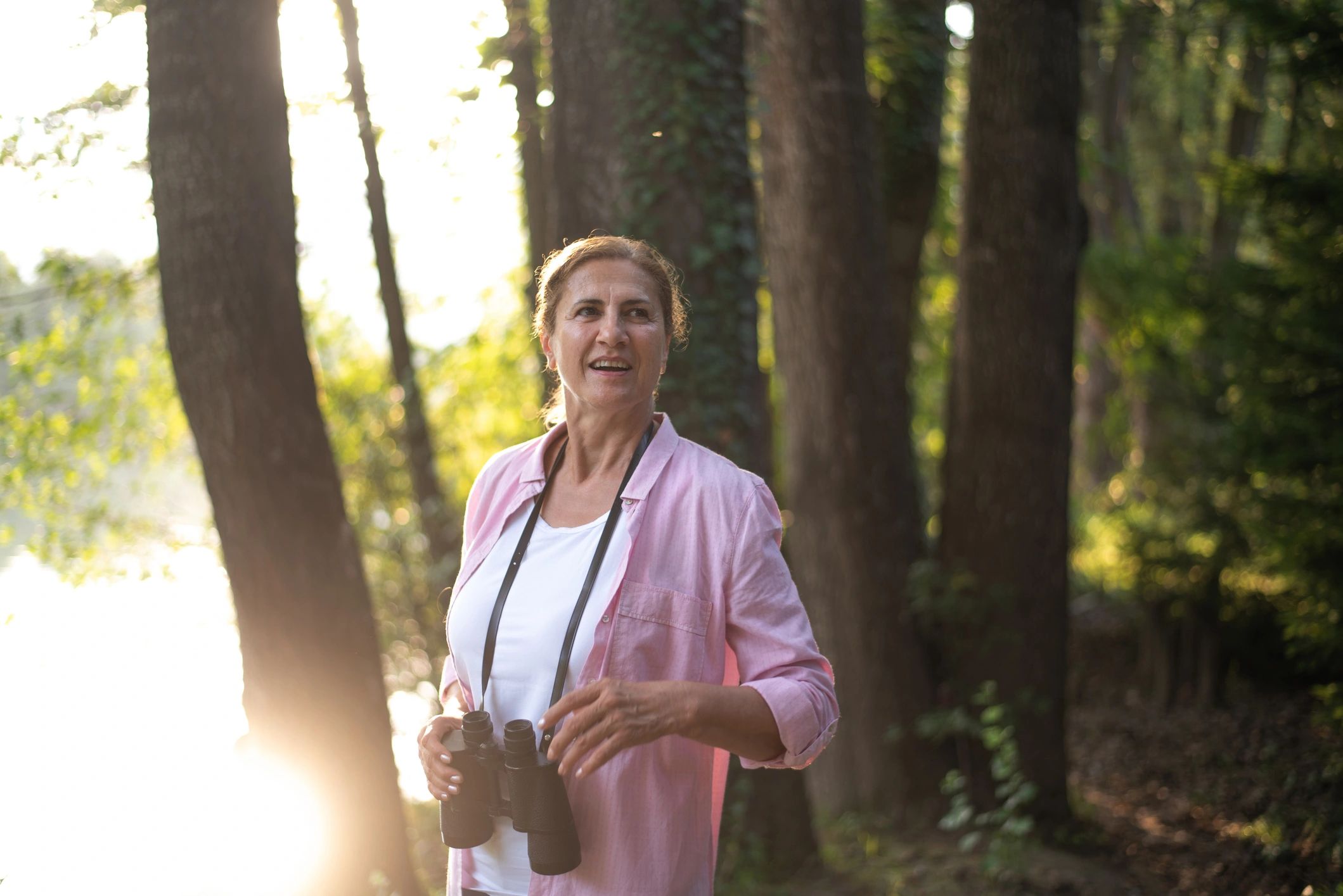 Woman exploring a nature setting with binoculars