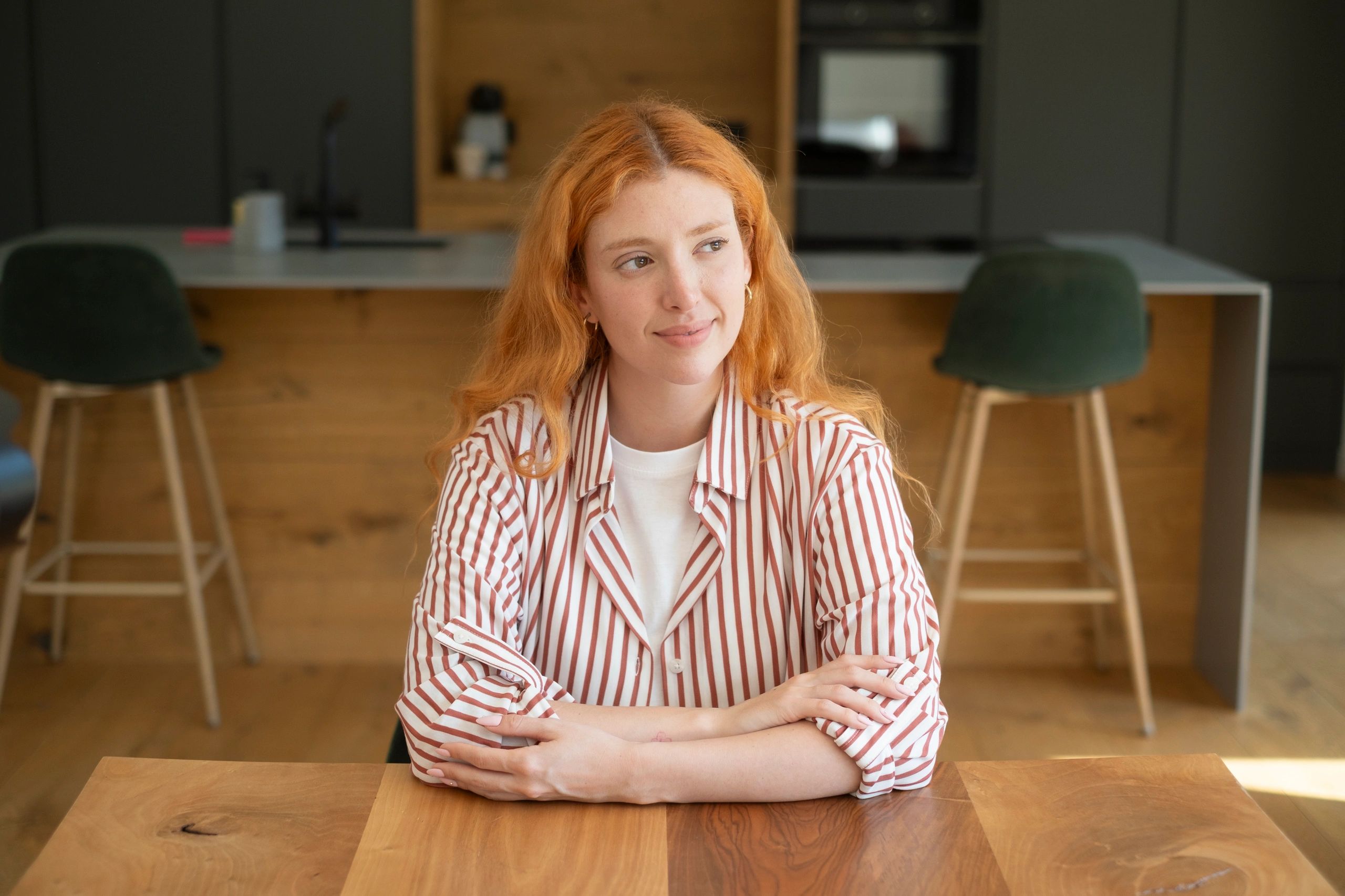 Woman sitting calmly indoors in a peaceful home setting